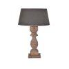 Wood lamp with a weathered finish, showcasing a rustic, textured surface that adds warmth and character to any room.