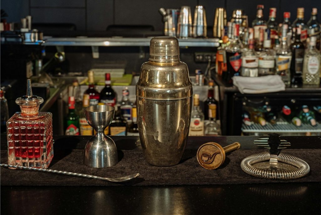 essential bar tools and barware items set on a table for home bar purpose.