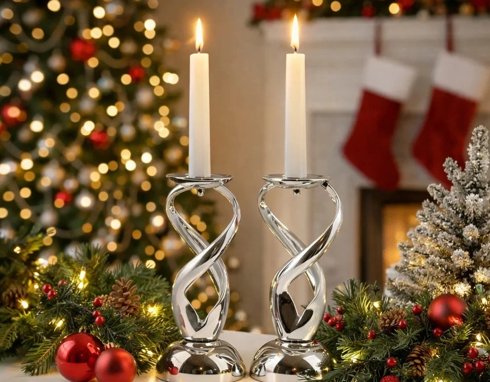 Elegant metal candle holders with lit white candles styled on a festive table with Christmas decorations and warm holiday lighting.